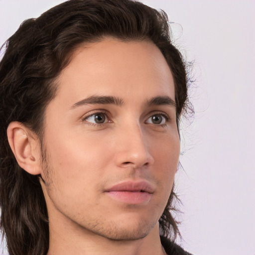 Neutral white young-adult male with long  brown hair and brown eyes