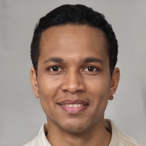 Joyful latino young-adult male with short  brown hair and brown eyes