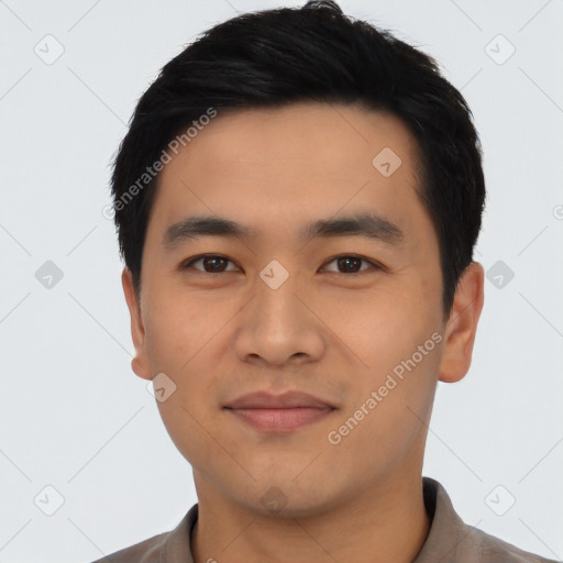 Joyful asian young-adult male with short  black hair and brown eyes