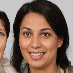 Joyful asian adult female with medium  brown hair and brown eyes