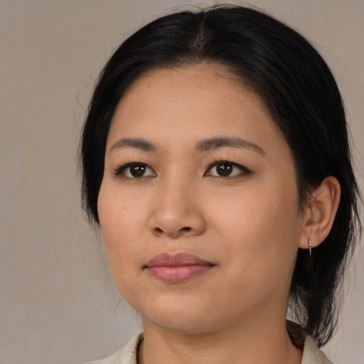 Joyful asian young-adult female with medium  black hair and brown eyes