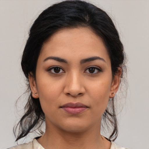 Joyful latino young-adult female with medium  black hair and brown eyes
