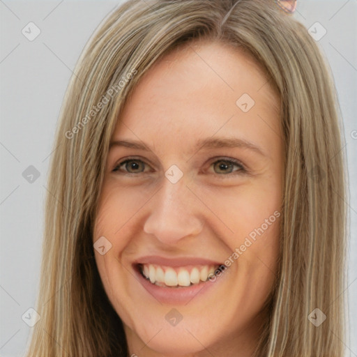 Joyful white young-adult female with long  brown hair and brown eyes