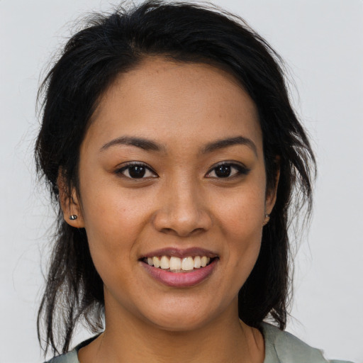 Joyful latino young-adult female with medium  brown hair and brown eyes