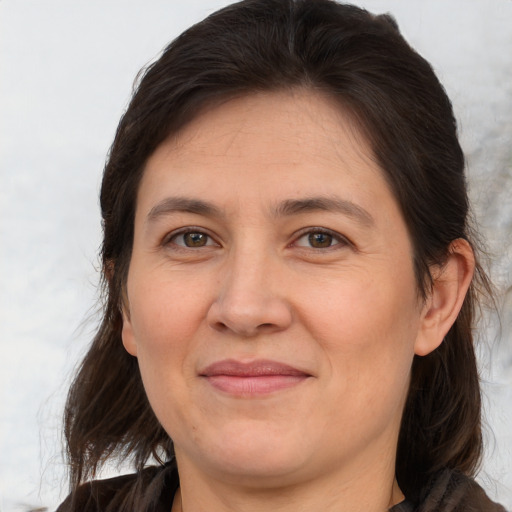 Joyful white adult female with medium  brown hair and brown eyes