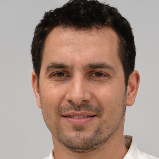 Joyful white adult male with short  brown hair and brown eyes