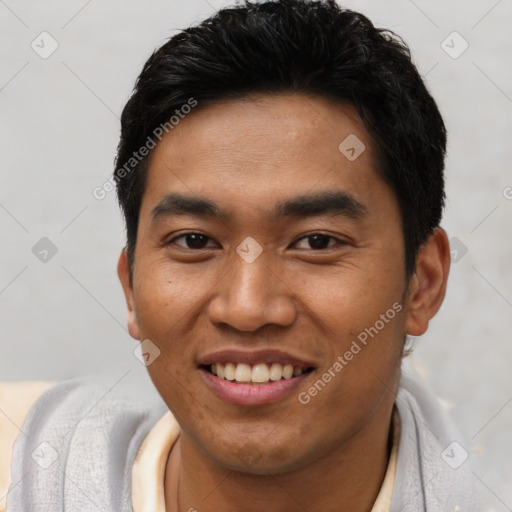 Joyful latino young-adult male with short  black hair and brown eyes