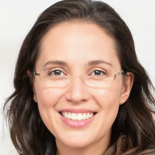 Joyful white adult female with long  brown hair and brown eyes