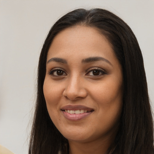 Joyful latino young-adult female with long  brown hair and brown eyes