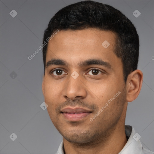 Joyful latino young-adult male with short  black hair and brown eyes
