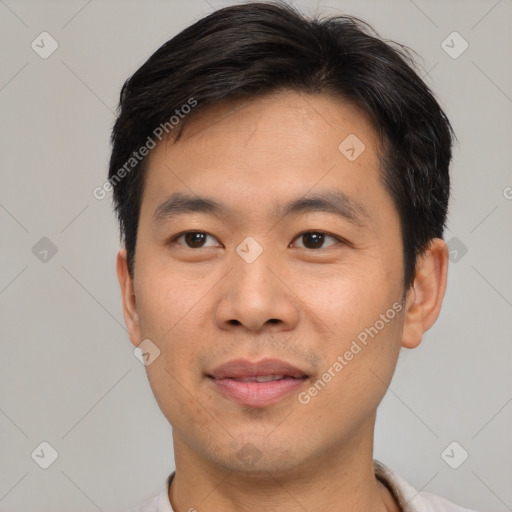 Joyful asian young-adult male with short  brown hair and brown eyes