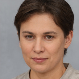 Joyful white adult female with short  brown hair and brown eyes