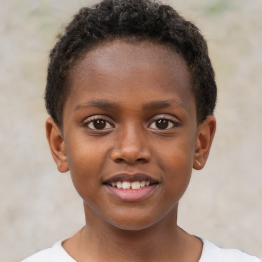 Joyful black child male with short  brown hair and brown eyes