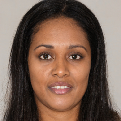 Joyful asian young-adult female with long  brown hair and brown eyes