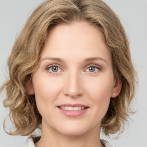 Joyful white young-adult female with medium  brown hair and green eyes