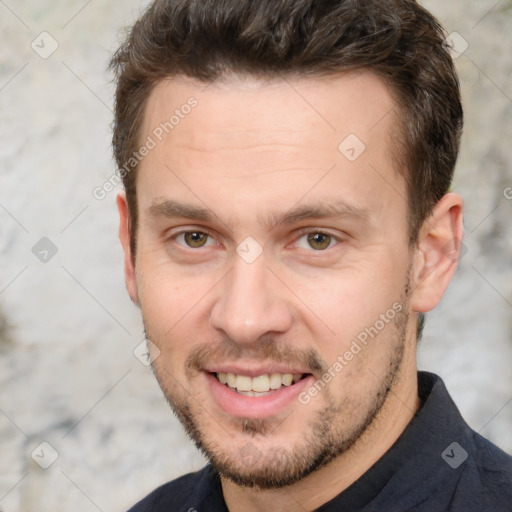 Joyful white adult male with short  brown hair and brown eyes