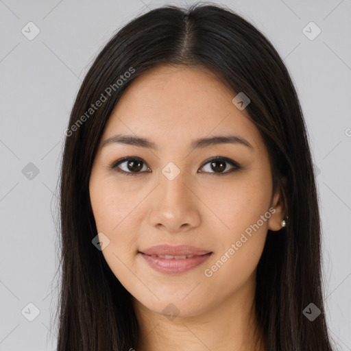 Joyful latino young-adult female with long  brown hair and brown eyes