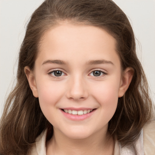 Joyful white child female with long  brown hair and brown eyes