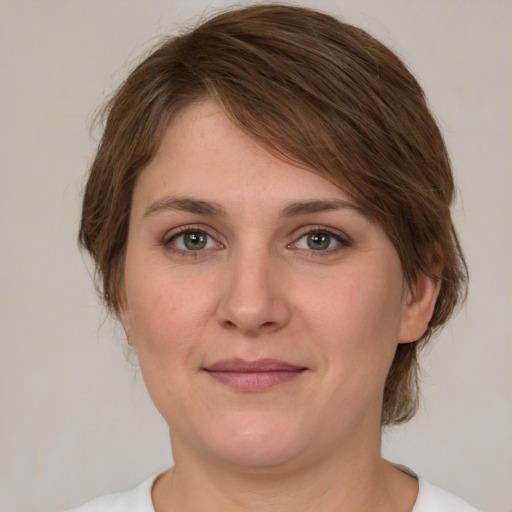 Joyful white young-adult female with medium  brown hair and green eyes