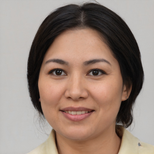Joyful asian young-adult female with medium  brown hair and brown eyes