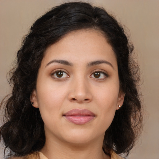 Joyful latino young-adult female with medium  brown hair and brown eyes