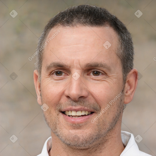 Joyful white adult male with short  brown hair and brown eyes