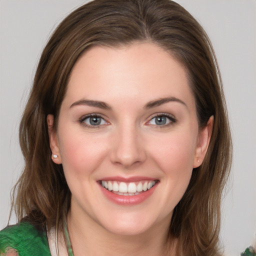 Joyful white young-adult female with medium  brown hair and green eyes