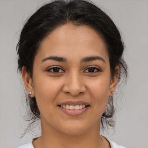 Joyful latino young-adult female with medium  brown hair and brown eyes