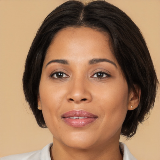 Joyful latino young-adult female with medium  brown hair and brown eyes