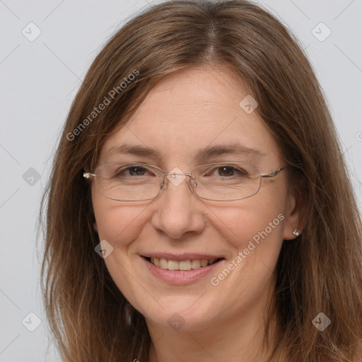 Joyful white adult female with long  brown hair and brown eyes