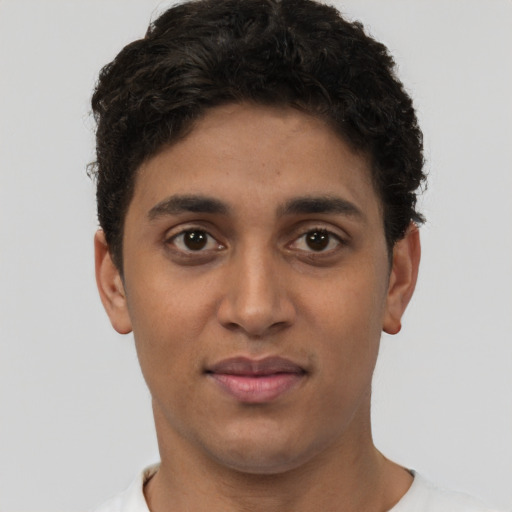 Joyful latino young-adult male with short  brown hair and brown eyes