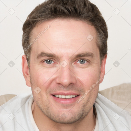 Joyful white adult male with short  brown hair and grey eyes