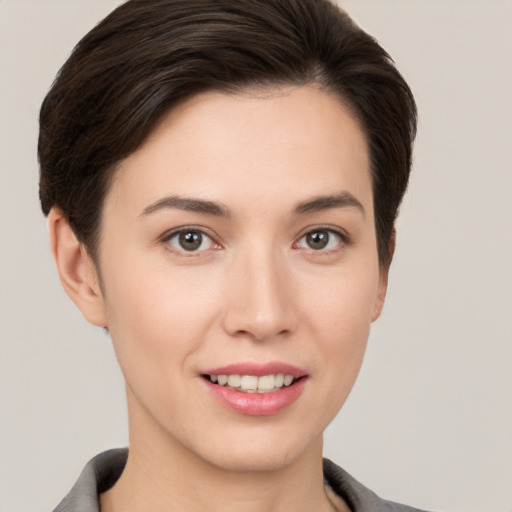 Joyful white young-adult female with short  brown hair and brown eyes