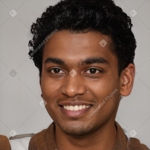 Joyful black young-adult male with short  brown hair and brown eyes