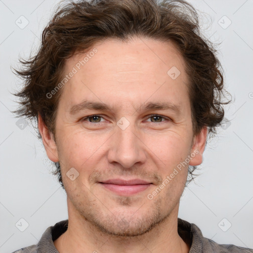 Joyful white adult male with short  brown hair and grey eyes