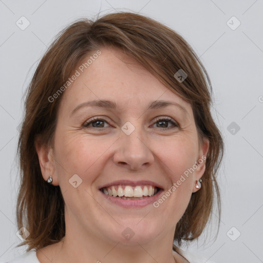 Joyful white adult female with medium  brown hair and blue eyes