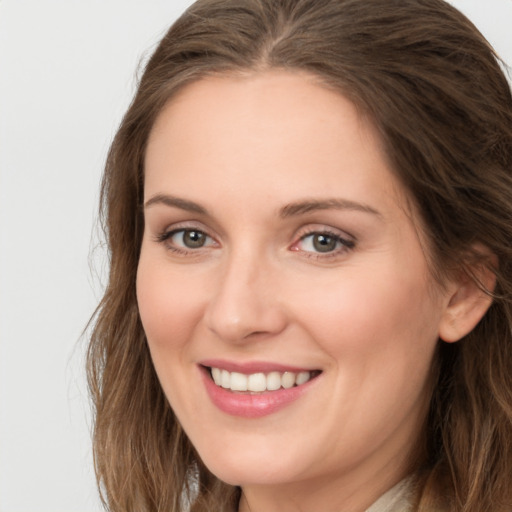 Joyful white young-adult female with long  brown hair and green eyes