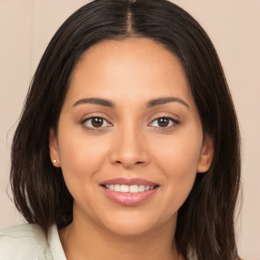 Joyful white young-adult female with long  brown hair and brown eyes