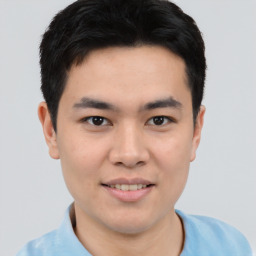 Joyful asian young-adult male with short  black hair and brown eyes