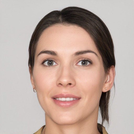 Joyful white young-adult female with medium  brown hair and brown eyes