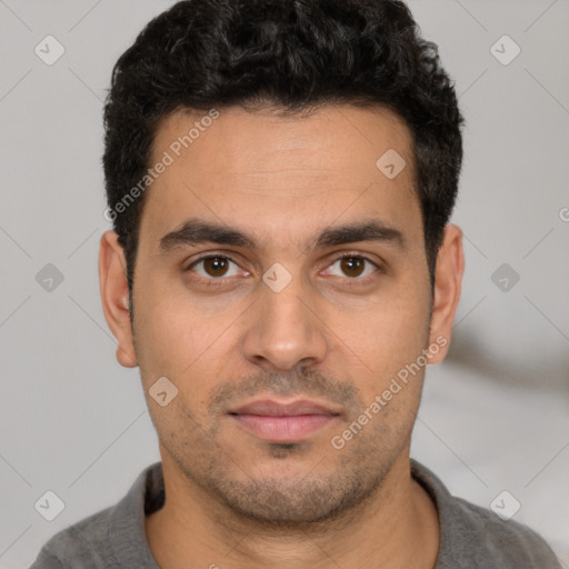 Joyful white young-adult male with short  black hair and brown eyes