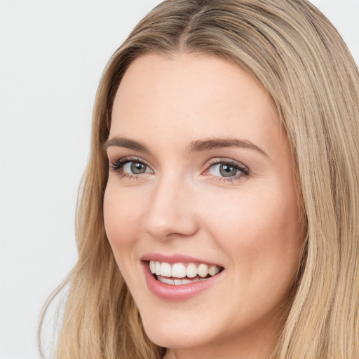 Joyful white young-adult female with long  brown hair and green eyes