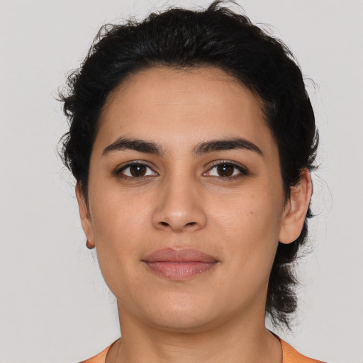Joyful latino young-adult female with short  brown hair and brown eyes