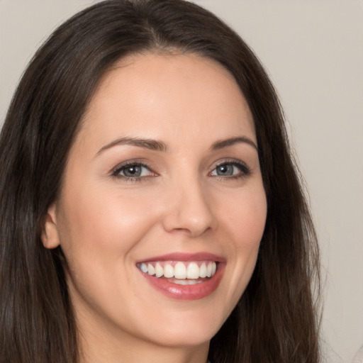 Joyful white young-adult female with long  brown hair and brown eyes