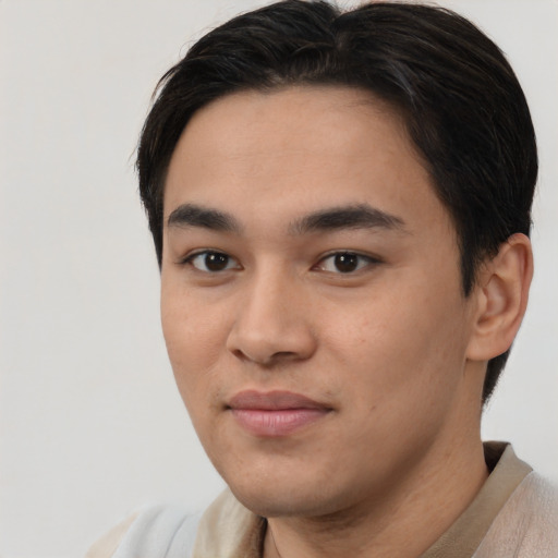 Joyful asian young-adult male with short  brown hair and brown eyes