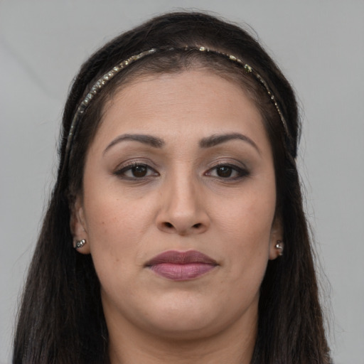 Joyful white young-adult female with long  brown hair and brown eyes