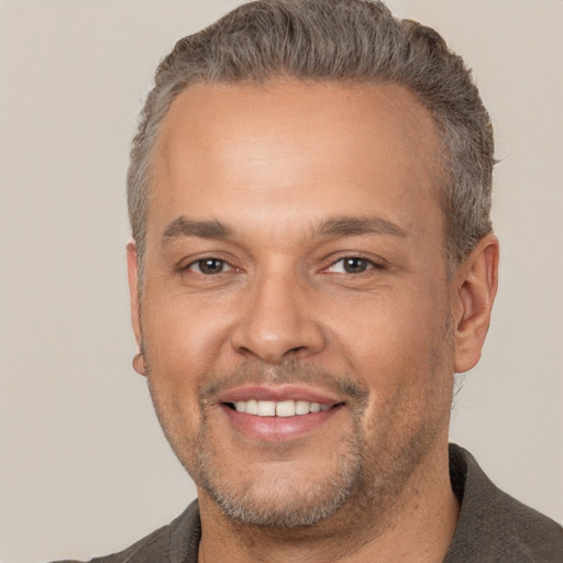 Joyful white adult male with short  brown hair and brown eyes