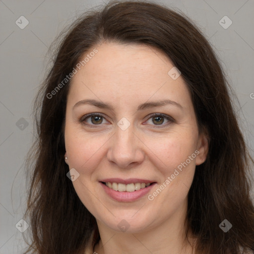 Joyful white adult female with long  brown hair and brown eyes