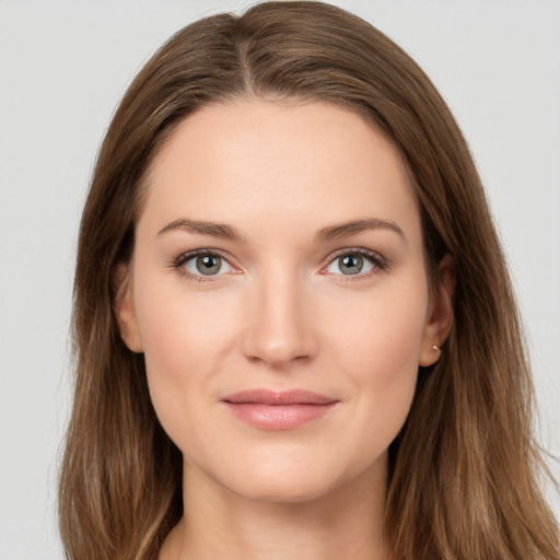 Joyful white young-adult female with long  brown hair and grey eyes