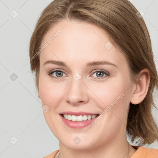 Joyful white young-adult female with medium  brown hair and blue eyes